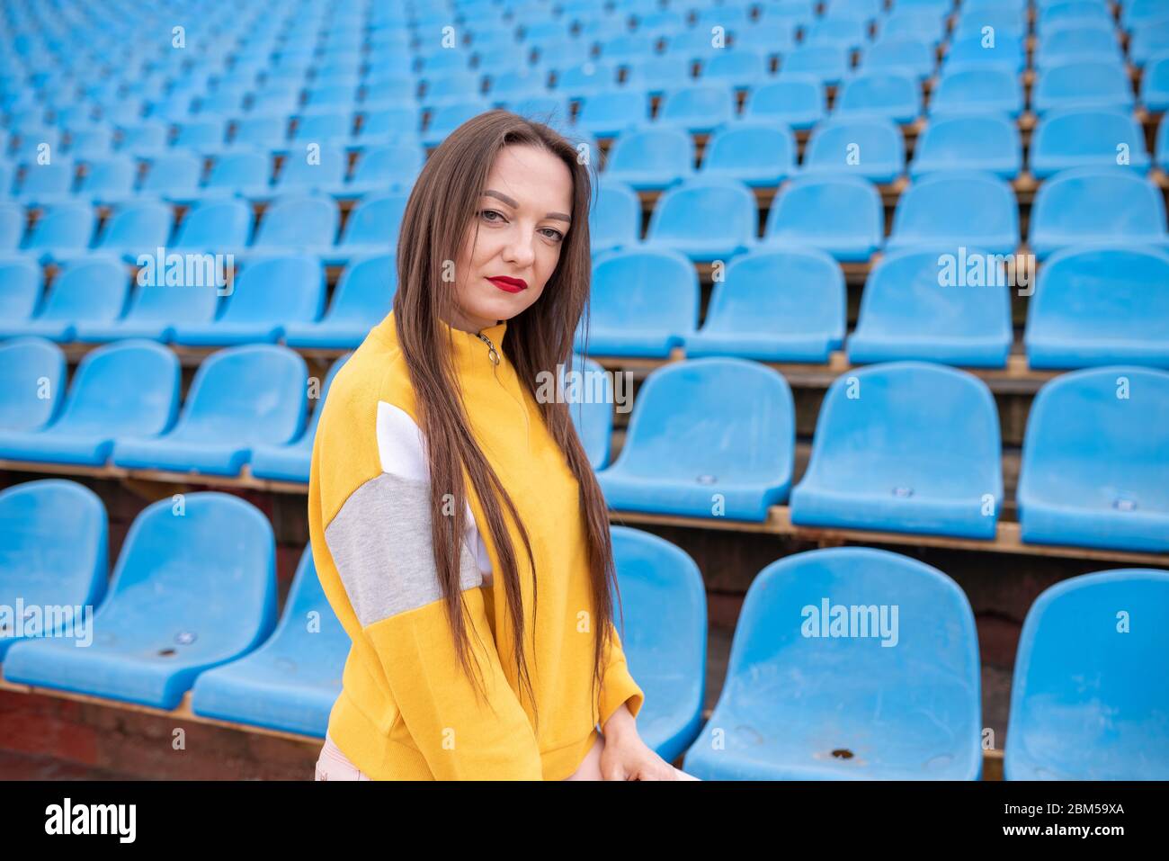 Girl alone in an empty stadium.  Stock Photo