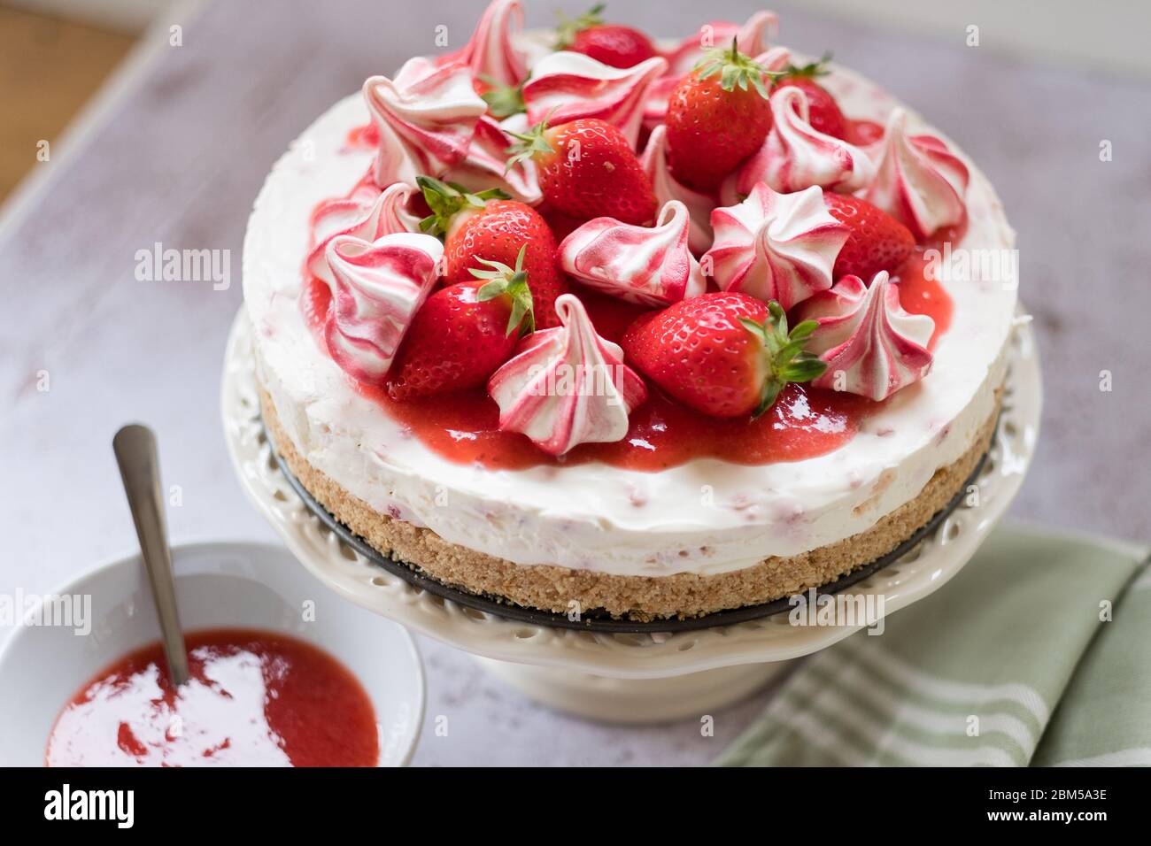 Delicious cheesecake on cake stand topped with fruit Stock Photo
