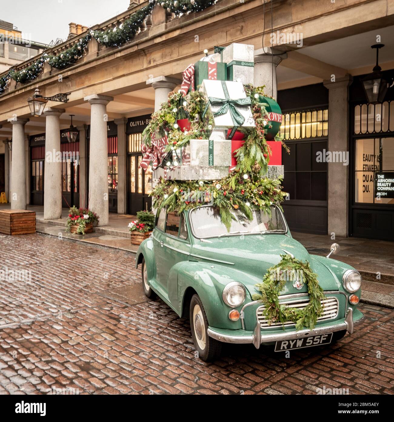 Christmas Shopping. An old English Morris Minor car stacked high with ...