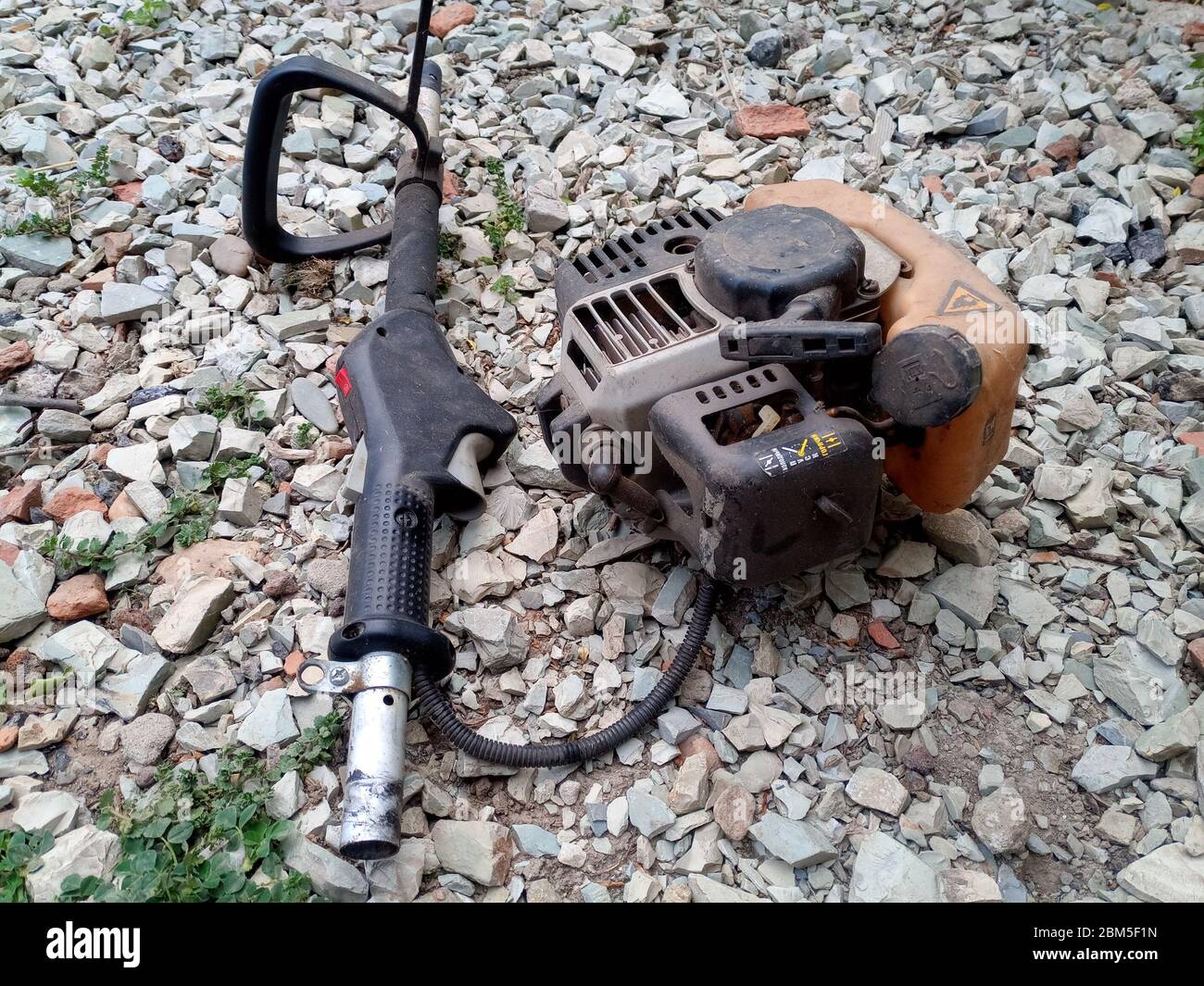 Parts from broken motos. Petrol trimmer disassembled. Stock Photo