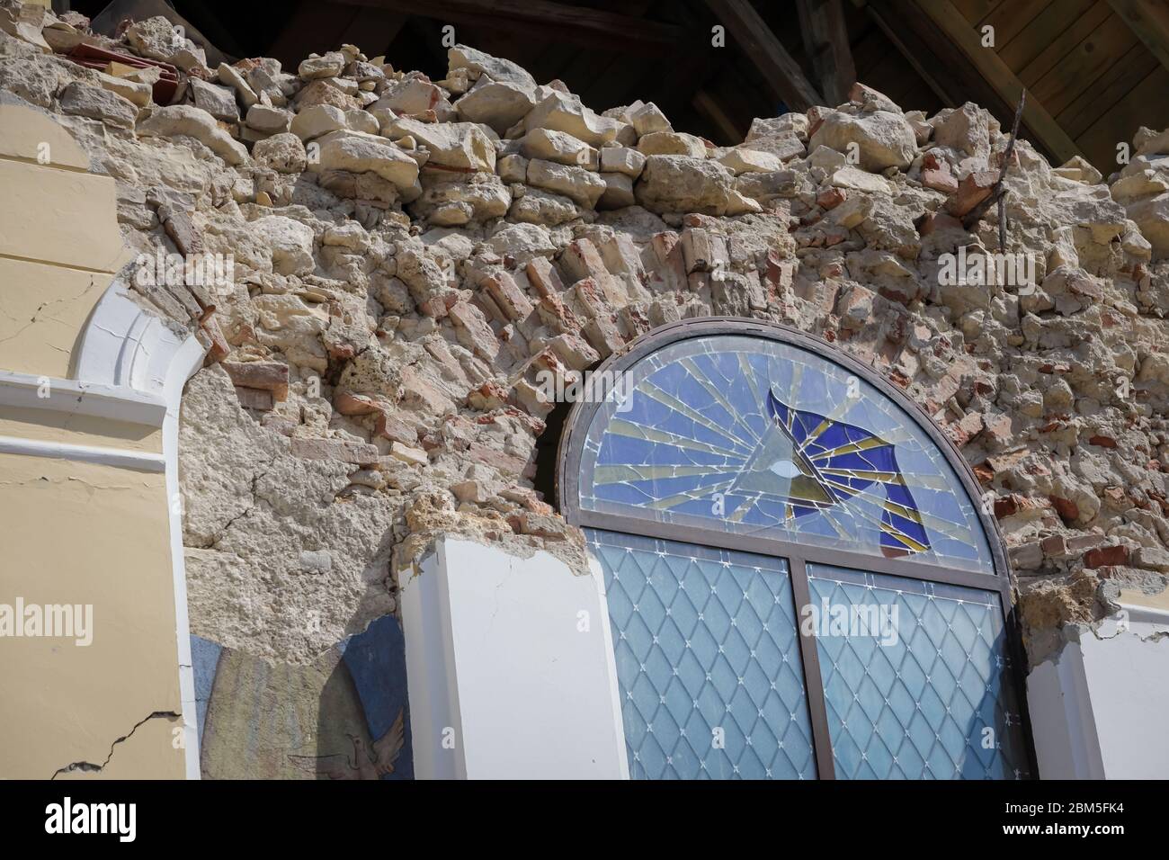 Zagreb, Croatia - 12 April, 2020 : Broken window with the Eye of Providence painting on the Church of the Visitation of the Blessed Virgin Mary, destr Stock Photo