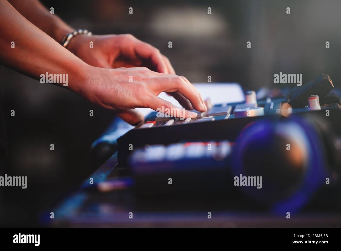 Dj plays beats on drum machine.Hip hop disc jockey playing on concert