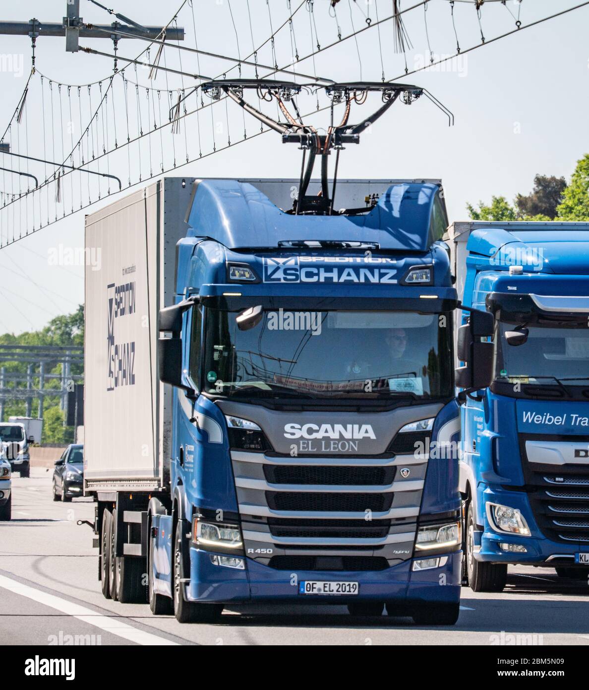 Erzhausen, Germany. 07th May, 2020. A Scania R450 hybrid tractor unit  (below) drives with the pantograph extended on the first German test track  for electric trucks with overhead contact lines on the