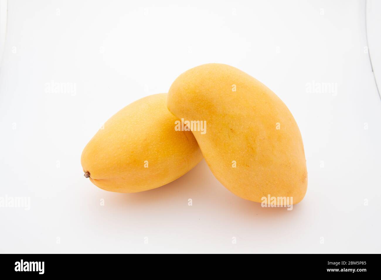 Close up one ripe yellow mango popular of fruit slices product isolated ...