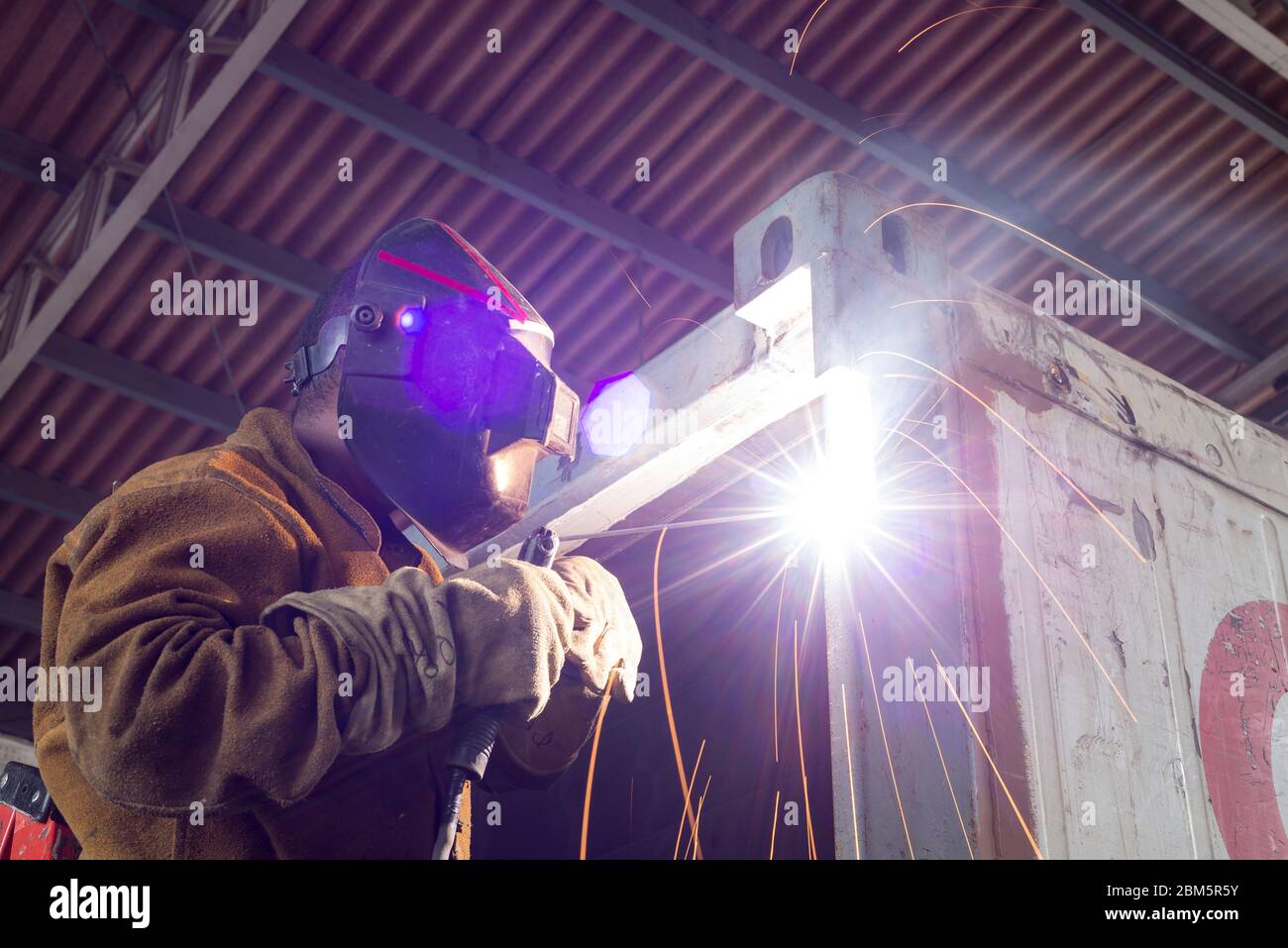 Welder working in a factory, Industrial worker Stock Photo
