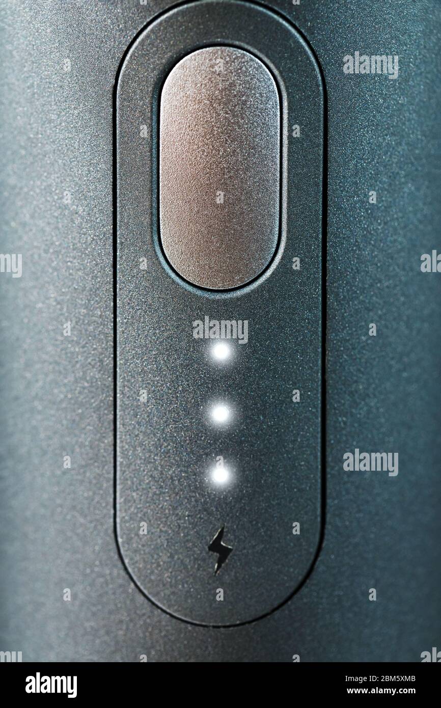 Button with led charging indication close-up. Control panel of the ...