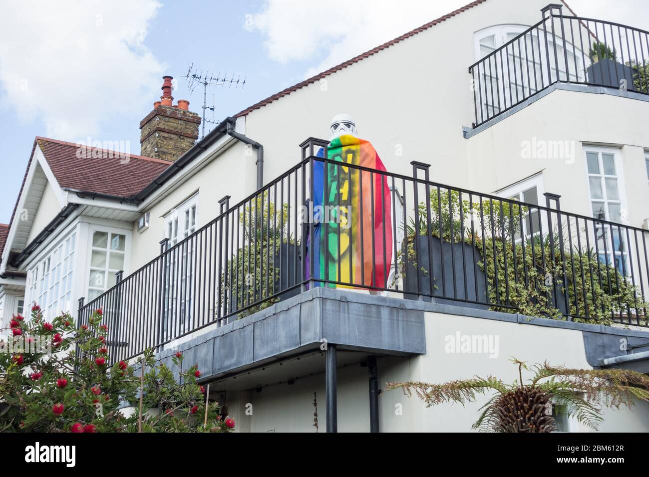 A lifesize Grand Army of the Republic Star Wars Stormtrooper cloaked in an NHS rainbow flag in Barnes, SW London, UK Stock Photo
