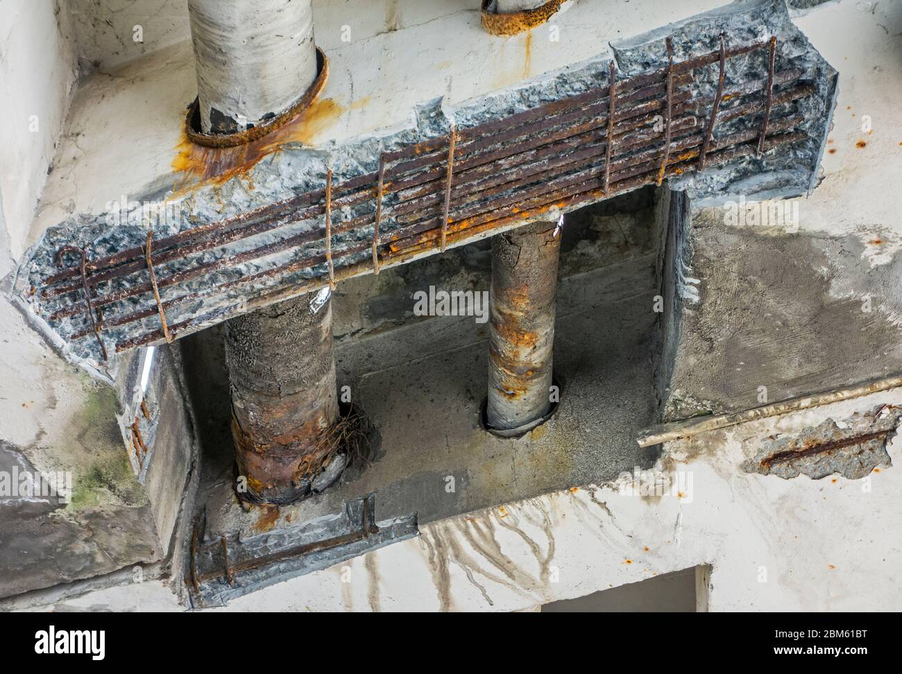 Repair work / renovation showing crumbling concrete and exposed reinforcing steel at Mariakerkebrug, 60s bridge in Mariakerke, East Flanders, Belgium Stock Photo