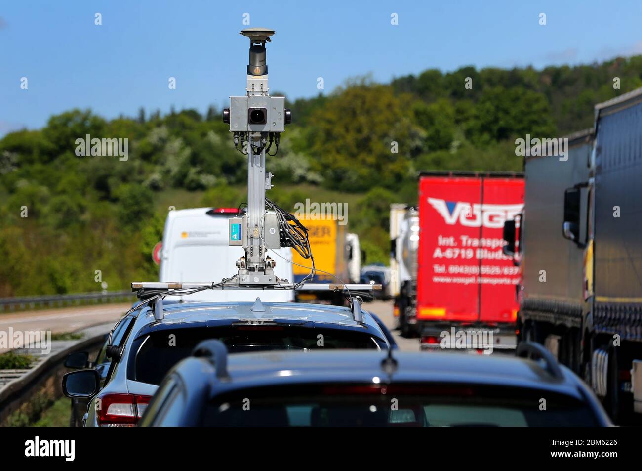 06 May 2020, Bavaria, Wörnitz: A survey vehicle of a Dutch navigation  manufacturer is stuck in a traffic jam on the A7 motorway. Camera and  scanner are collecting data material to optimize