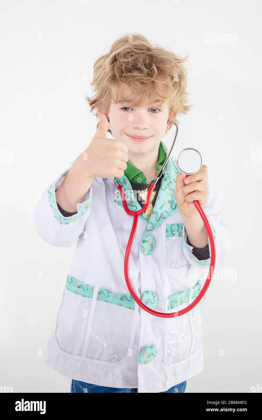 busy young doctor shows thumbs up, a symbol of good luck Stock Photo