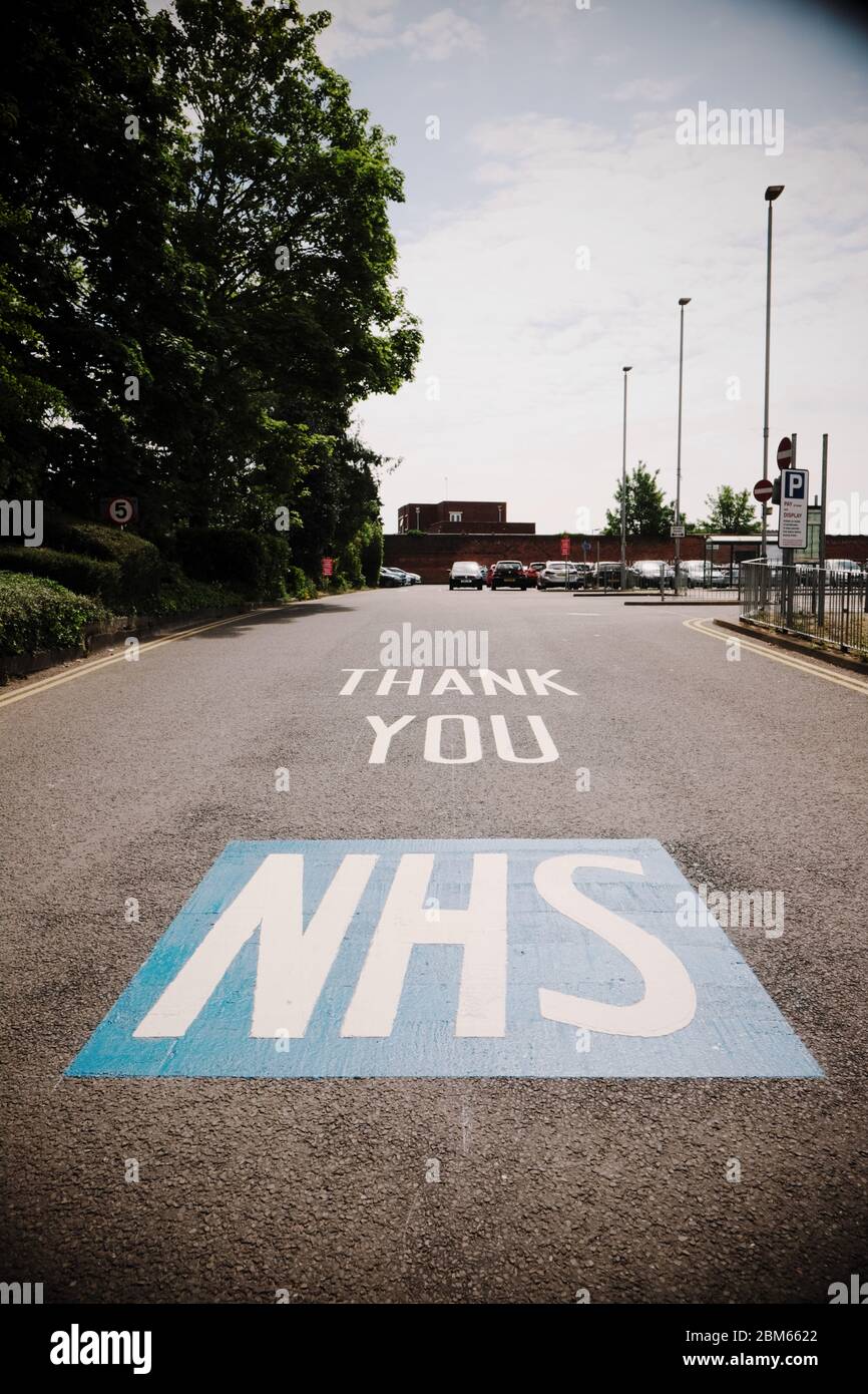 Thank You NHS sign painted on the road surface entrance to a hospital car park in Hereford UK during the Coronavirus crisis Stock Photo