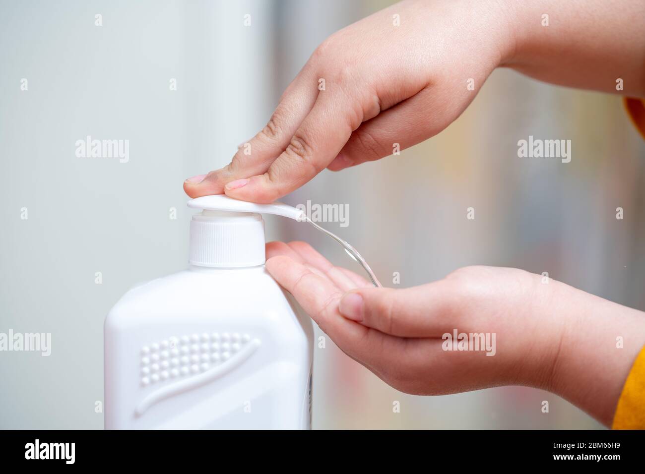 Disinfecting your hands with sanitizer for disinfection and killing the viruses on your hands. Stock Photo