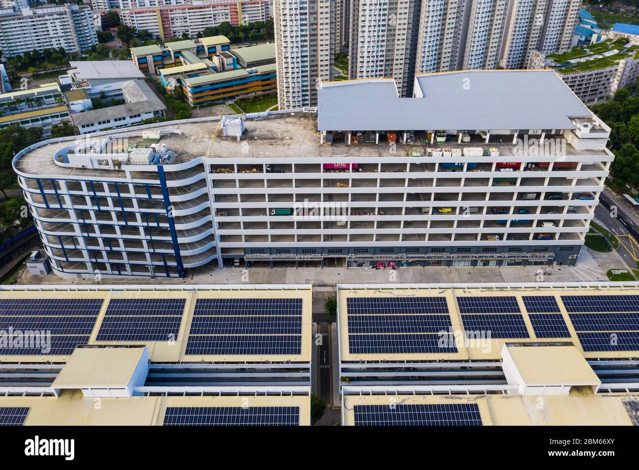 Aerial view of a Light Industrial building and solar panels mounted on the industry roof to absorb light energy, Singapore. Stock Photo