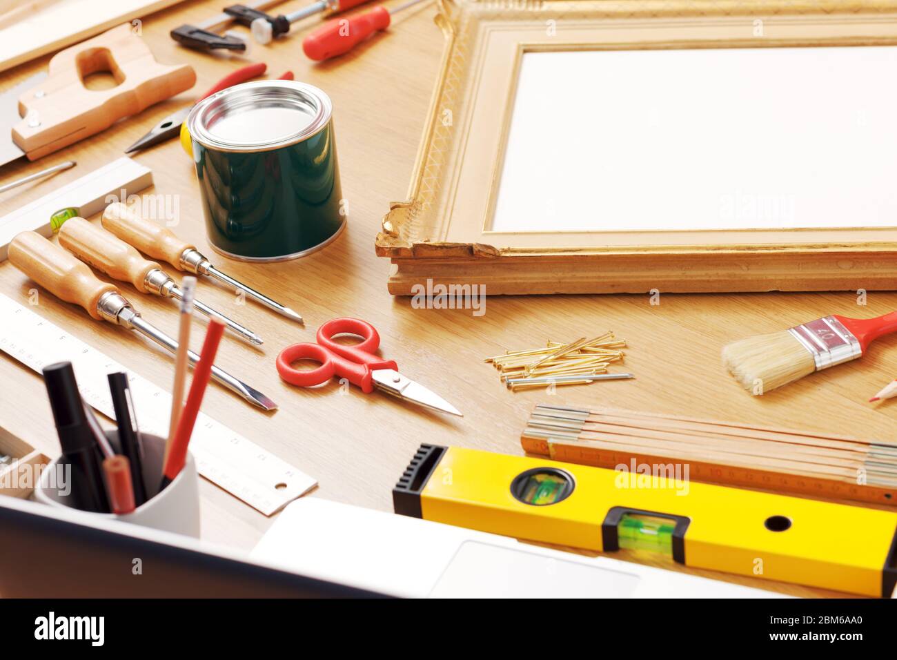 Decorator work table with varnish bucket, DIY tools and wooden frame, hobby and craft concept Stock Photo