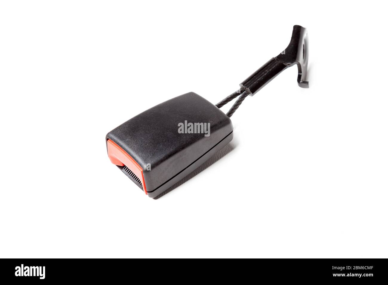 Black plastic seat belt lock with red button on a white isolated