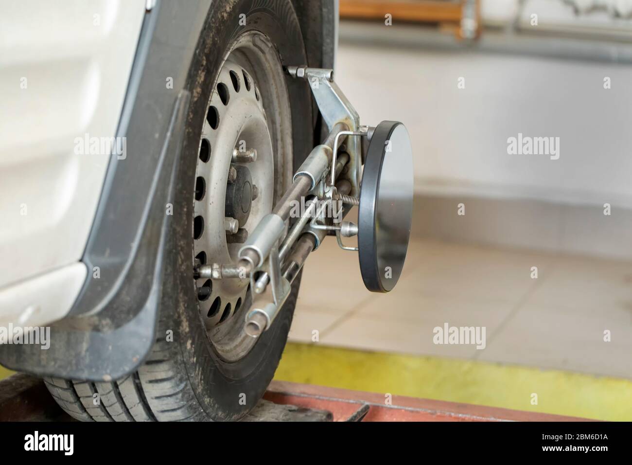 Adjusting the chassis of the car. Performing wheel alignment works at