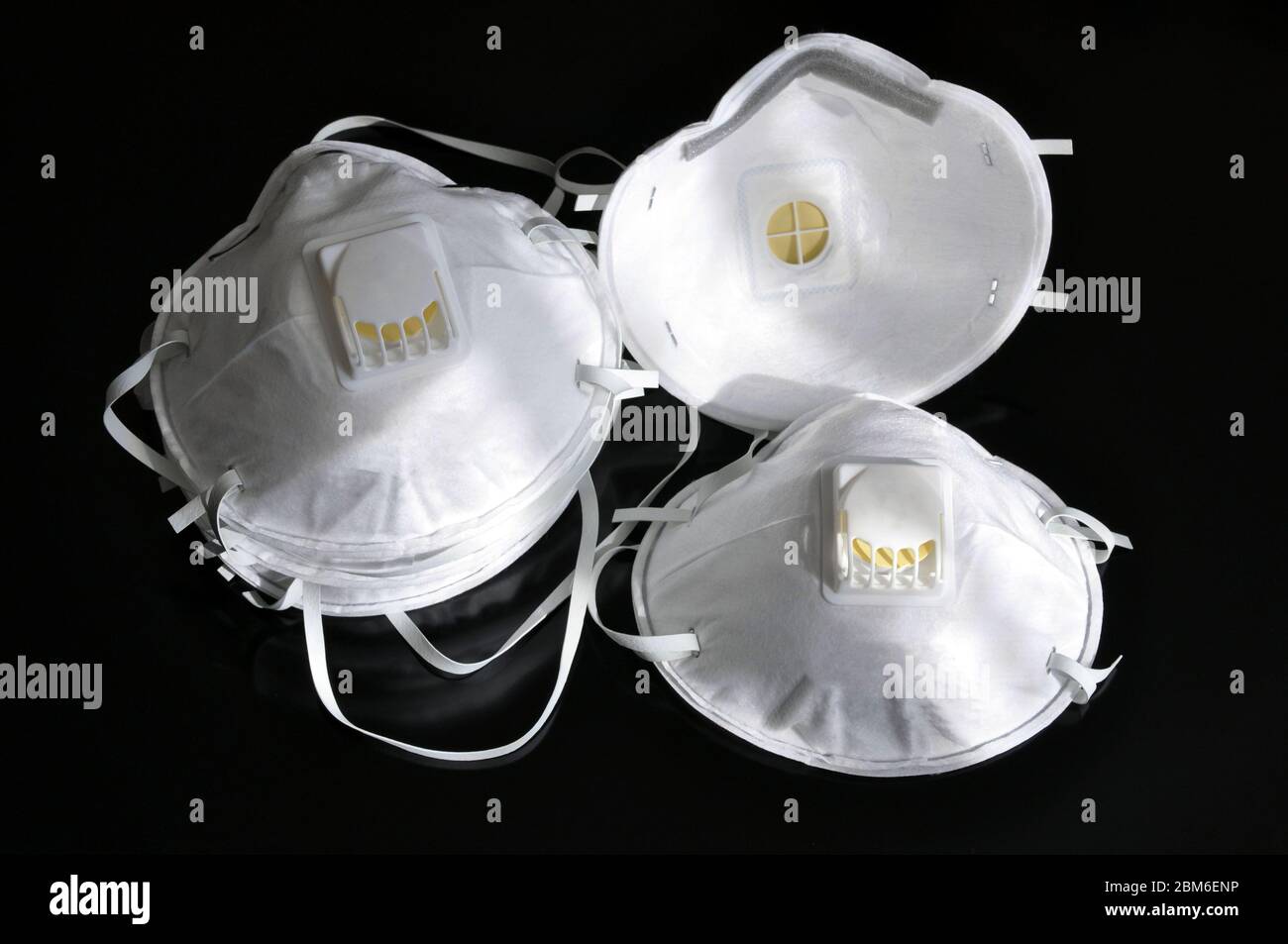 Set of white masks on a black background. Respirator with ventilation ...