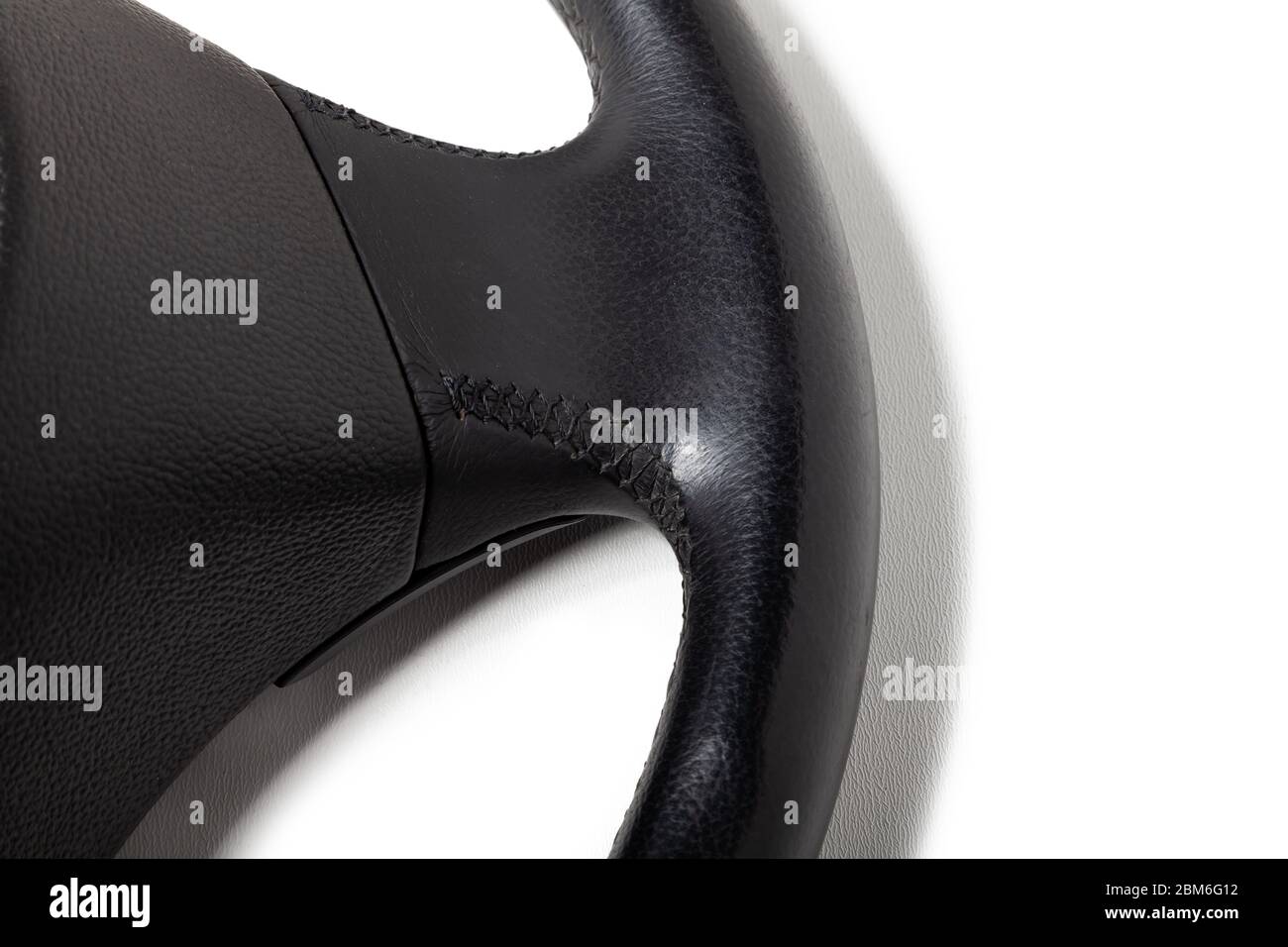 Leather steering wheel black color in the process of stitching with a