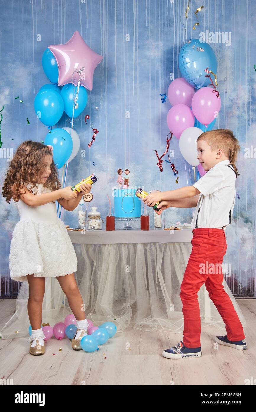 Children's funny birthday party in decorated room. Happy kids celebrate International Children's Day Stock Photo