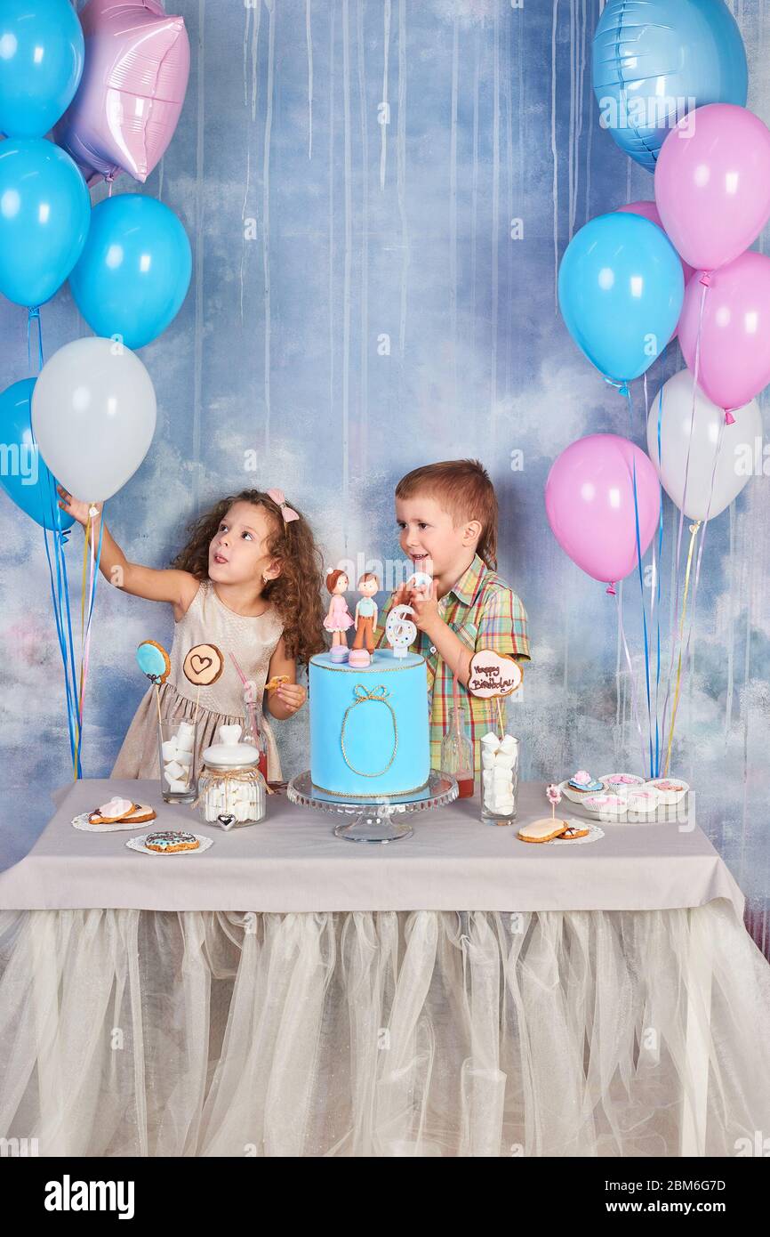 Children's funny birthday party in decorated room. Happy kids celebrate International Children's Day. Funny kids Stock Photo