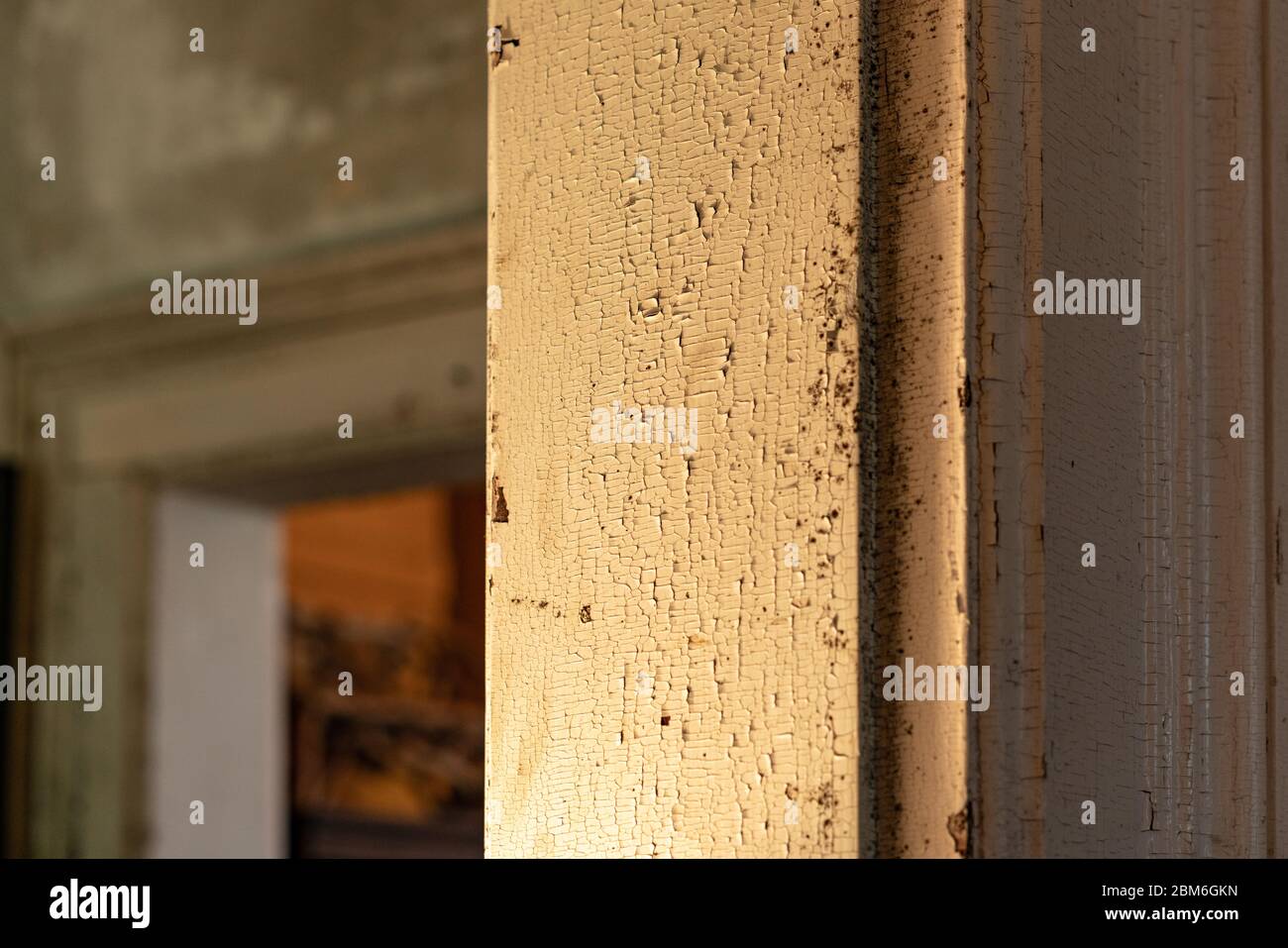 A worn door frame with peeling white paint Stock Photo Alamy