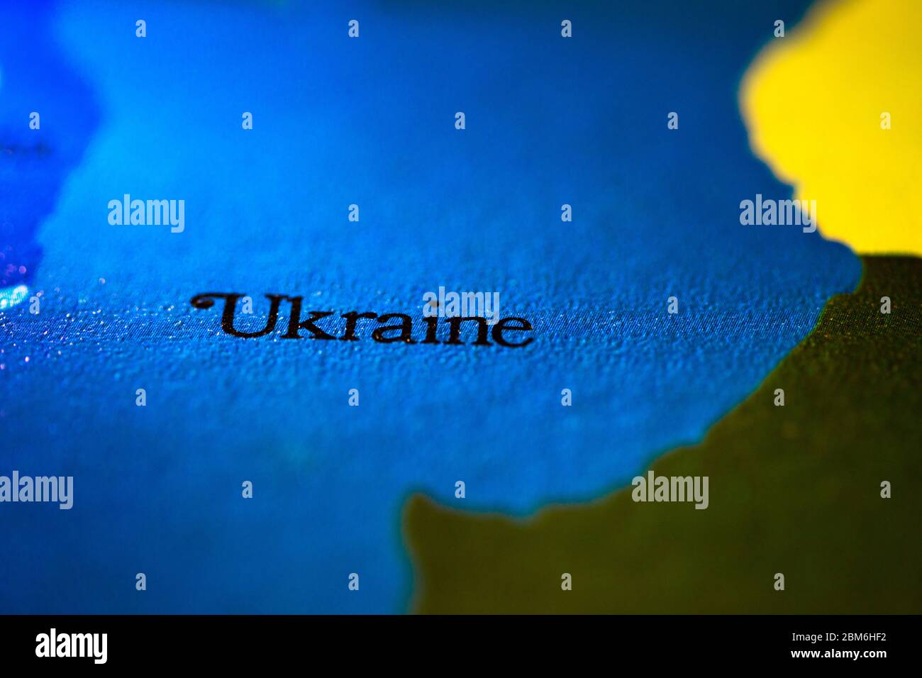 Shallow depth of field focus on geographical map location of country Ukraine in Europe continent on atlas Stock Photo