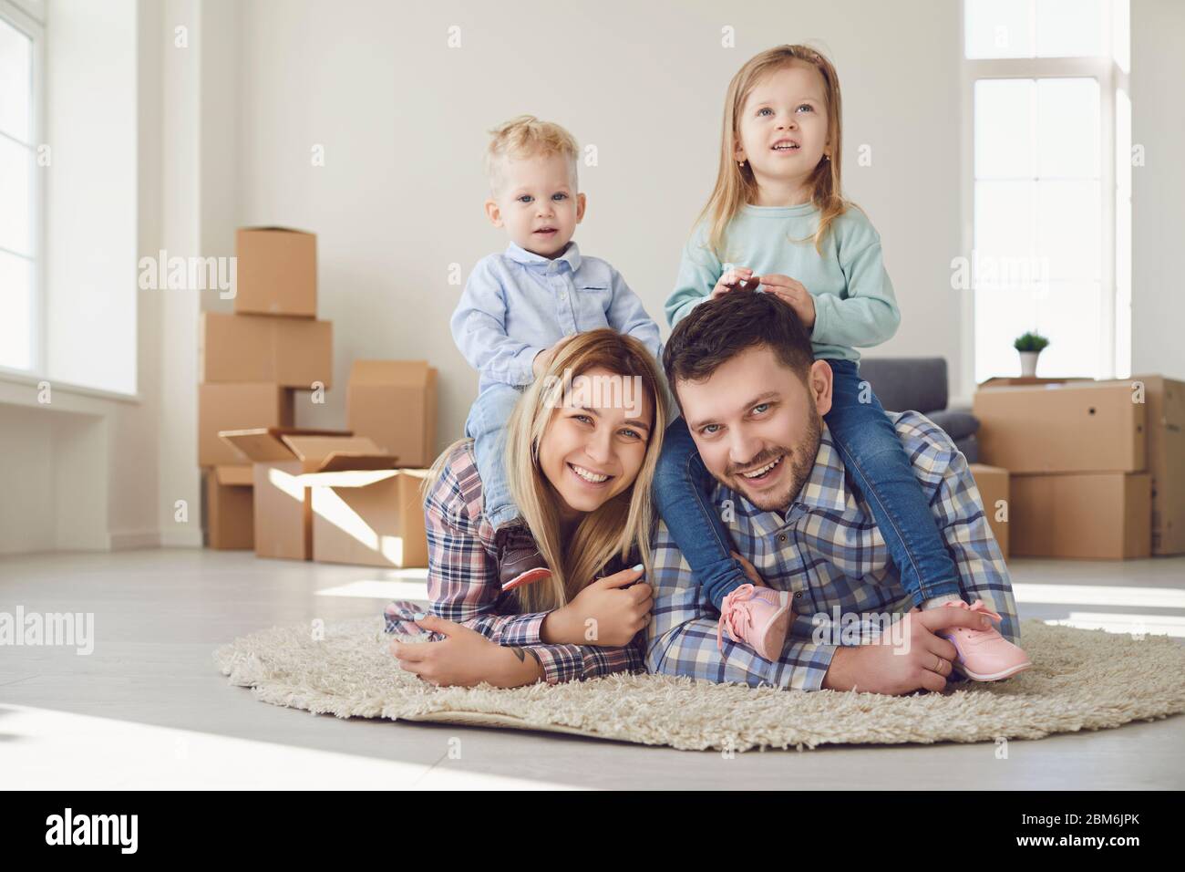 Happy family smiling at a new house moving. Stock Photo