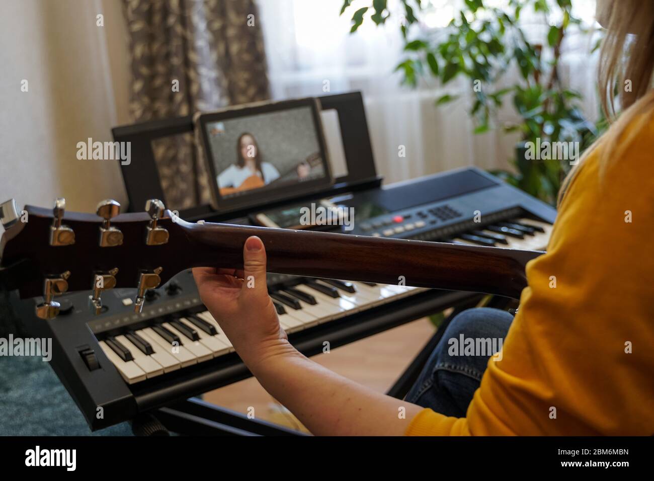 Musicians rehearse online in isolation because of the coronavirus pandemic. Learning music at home. Stock Photo
