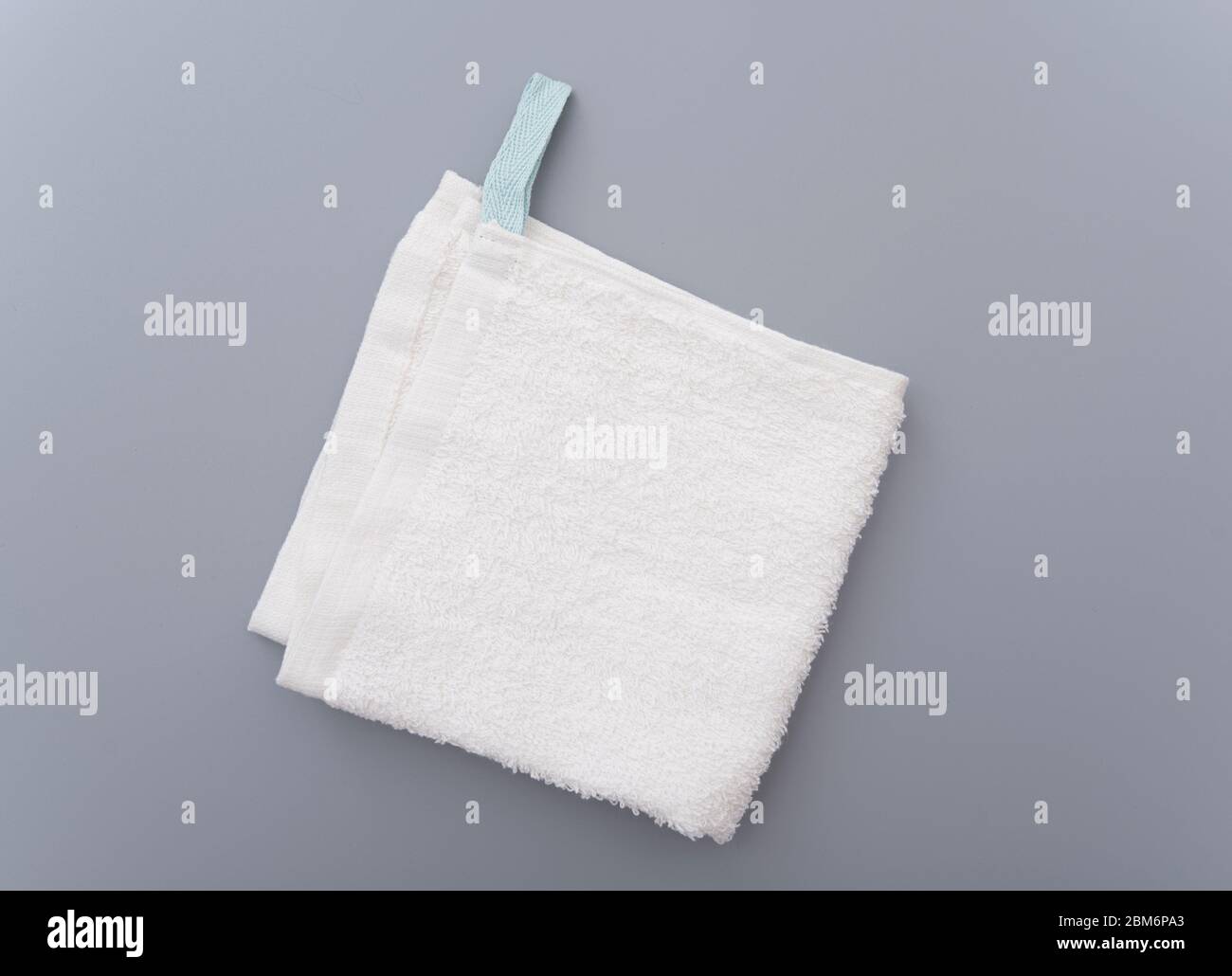 White bath towel on gray background Stock Photo