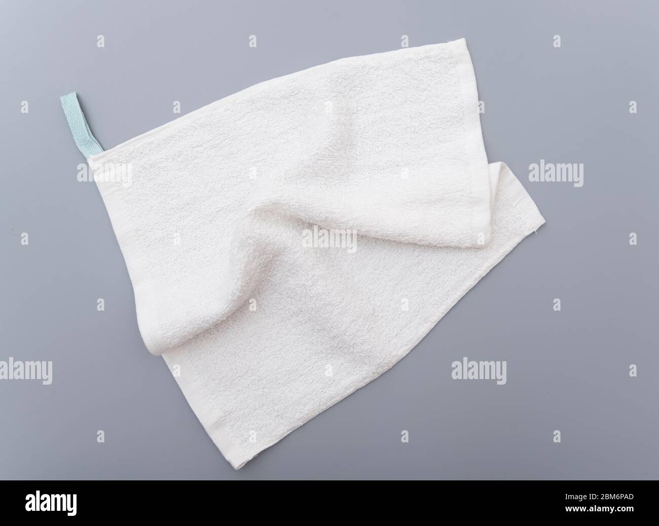 White bath towel on gray background Stock Photo