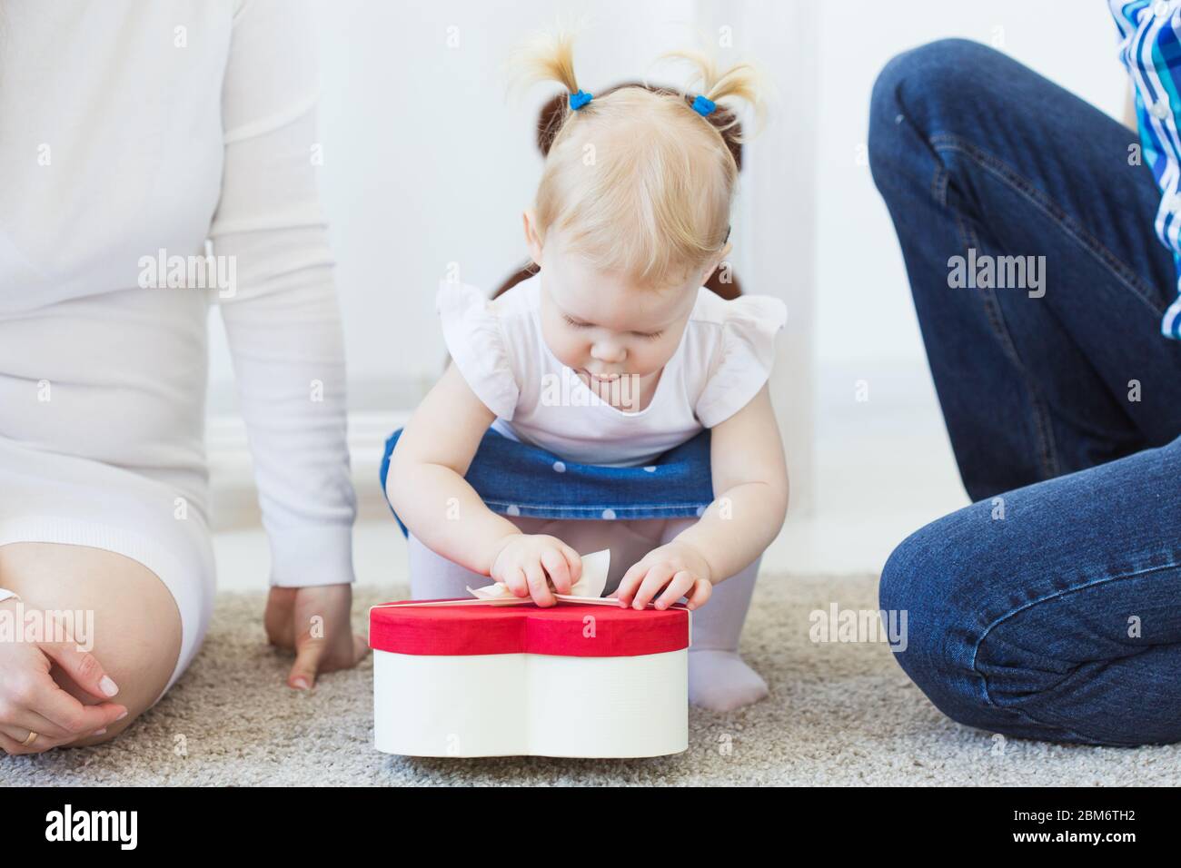 Hearing aid in baby girl's ear. Toddler child wearing a hearing aid at