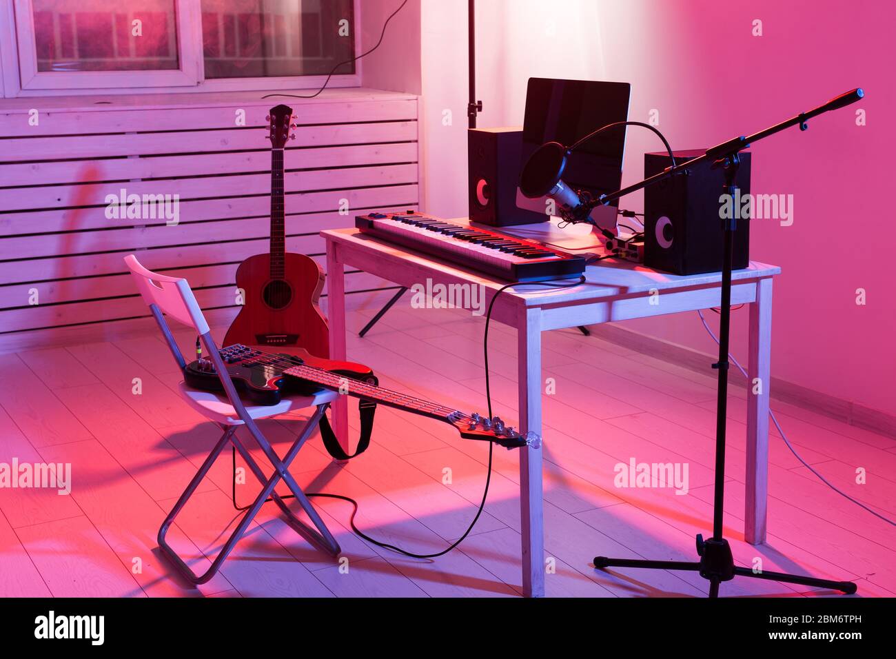 Microphone, computer and musical equipment guitars and piano background.  Home recording studio concept Stock Photo - Alamy