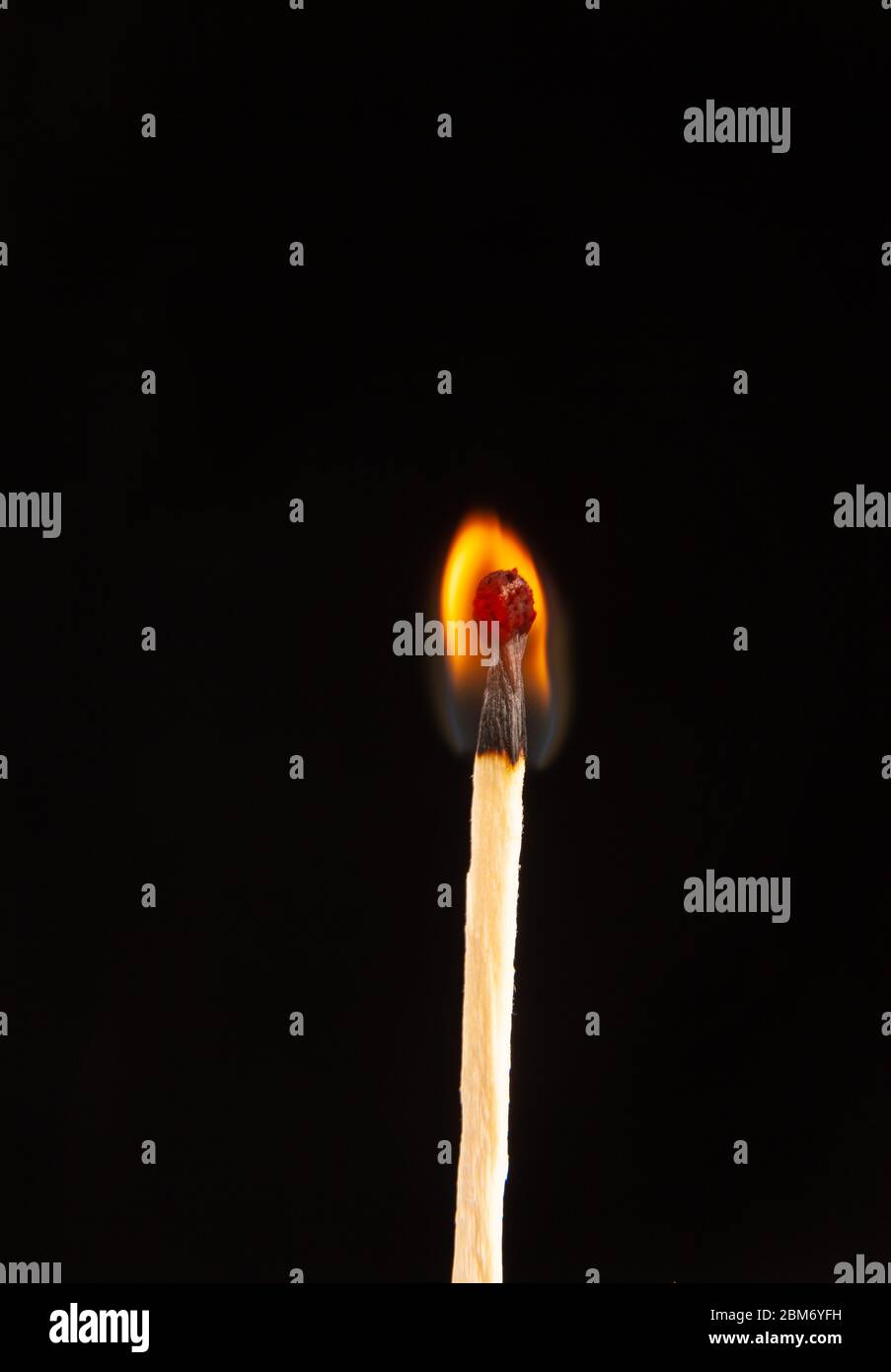 A burning matchstick on black background Stock Photo