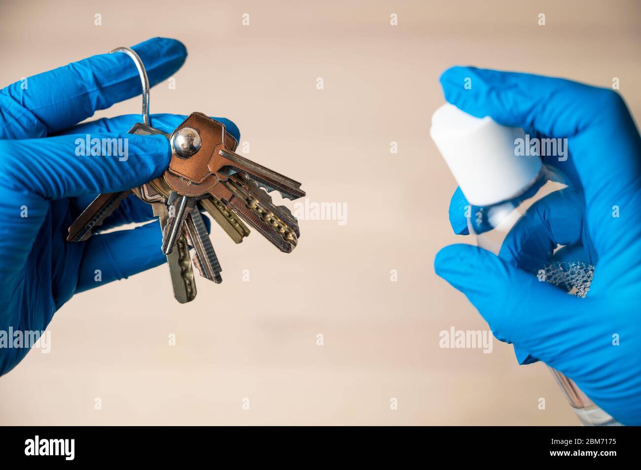 Cleaning and disinfecting keys. Cleaning personal items from virus, microbes and dirt. Coronavirus prevention concept and safety measures. Stock Photo