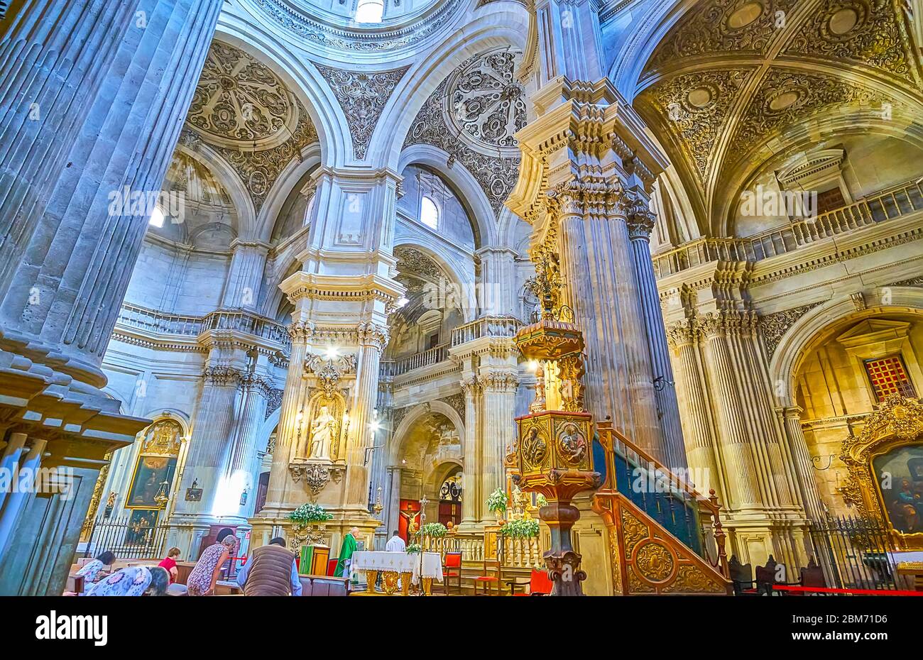 GRANADA, SPAIN - SEPTEMBER 27, 2019: Explore historic Baroque prayer hall of Sagrario (Sacred Heart) church with relief stone columns, ornate domes, c Stock Photo