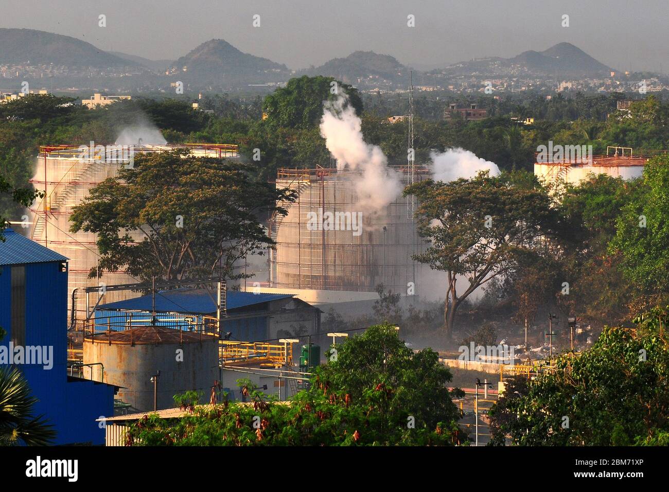 Andhra Pradesh, India. 7th May, 2020. Smoke rises after a gas leakage at the 'LG Polymers' chemical plant in the Vishakhapatnam district of Andhra Pradesh, India, May 7, 2020. The death toll in Thursday's gas leak incident in India's southern state Andhra Pradesh has risen to 11, confirmed Director General of the National Disaster Response Force (NDRF) S.N. Pradhan while addressing media persons in Delhi. Credit: Str/Xinhua/Alamy Live News Stock Photo