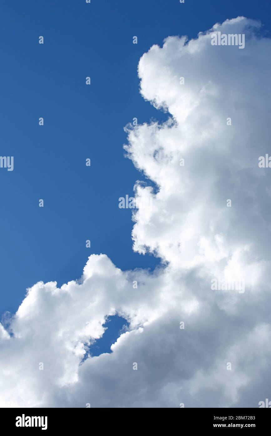 Edge of a human shaped white cloud on blue sky , Finland Stock Photo