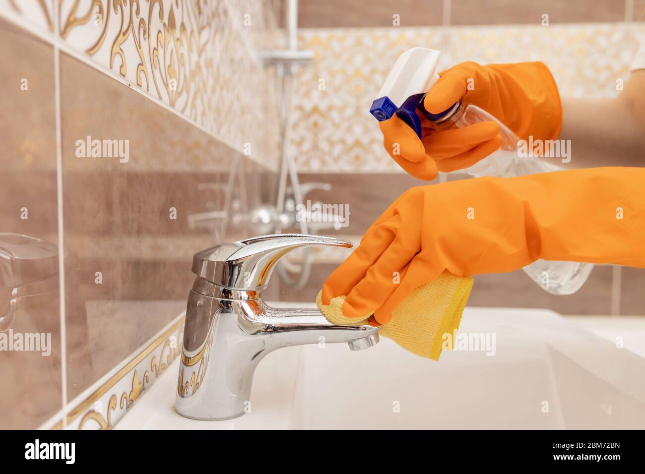 Cleaning tap from limescale in bathroom, disinfecting surface from