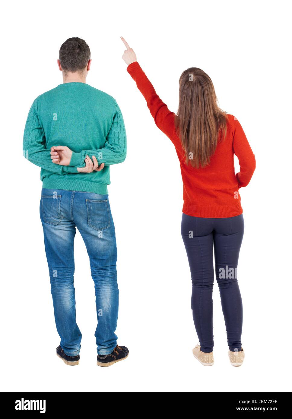 Back view of couple in sweater pointing. Rear view people collection ...