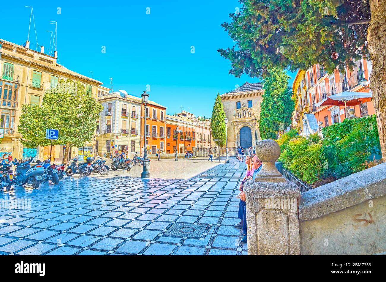 GRANADA, SPAIN - SEPTEMBER 25, 2019: The shady Santa Ana square with a view on historical edifices and facade of San Gil and Santa Ana church, on Sept Stock Photo
