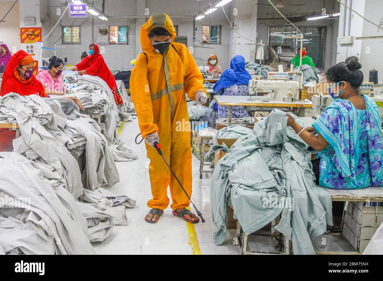 Dhaka, Bangladesh. 7th May, 2020. A worker sprays disinfectant at a garment factory in Dhaka
