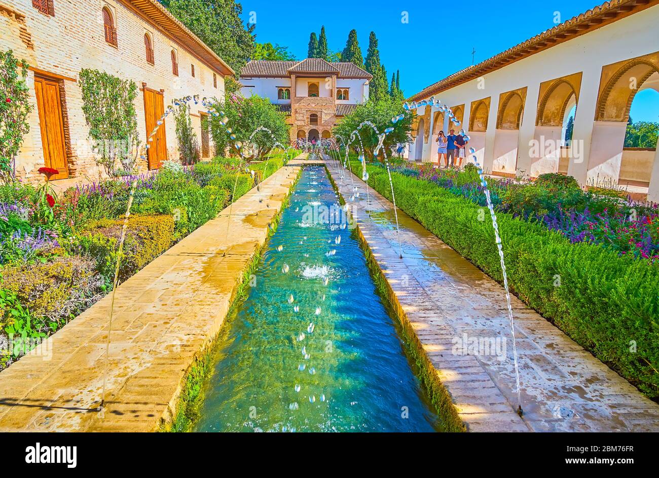 GRANADA, SPAIN - SEPTEMBER 25, 2019: The topiary garden in Patio of Irrigation Ditch of Generalife (Alhambra) with fountains and medieval irrigation c Stock Photo