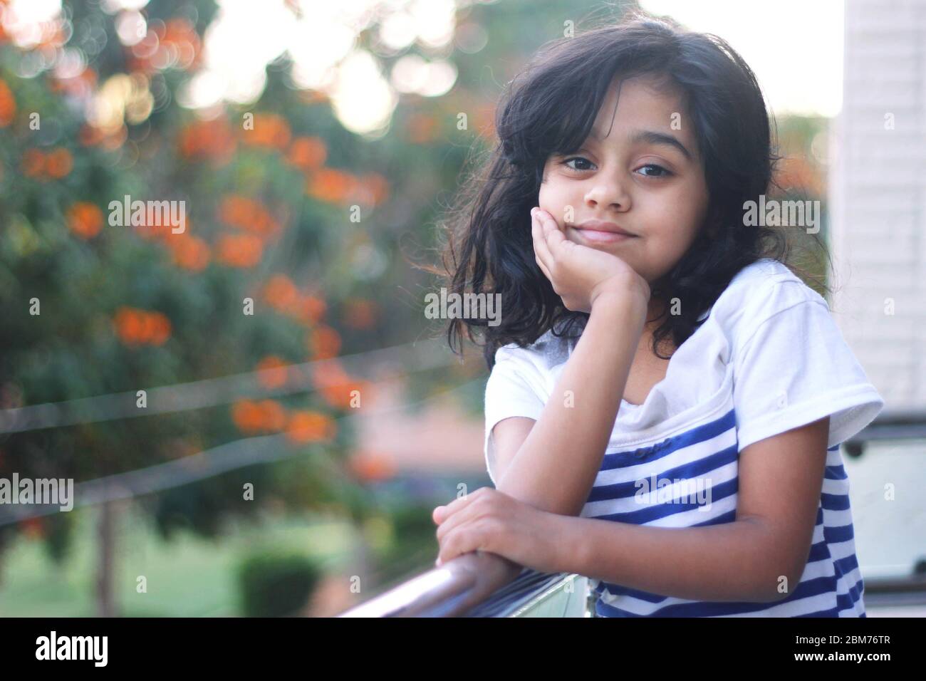 Adorable little girl posing for the photograph Stock Photo - Alamy