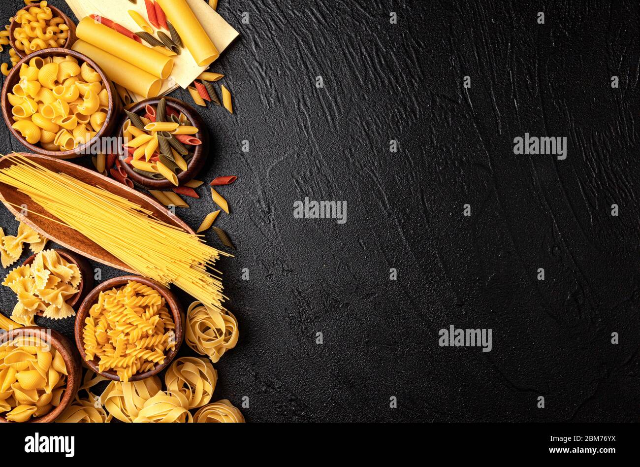 Different pasta types on black background with copy space for text Stock Photo