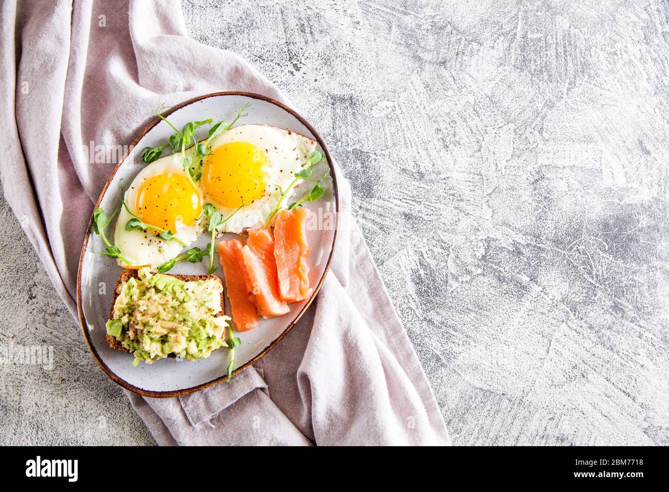 Egg breakfast. Healthy nutritious breakfast with eggs, salmon, avocado