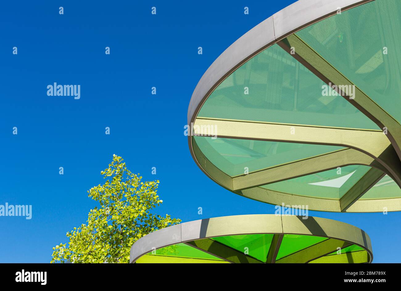 Modern roofing for the bus stop. Interesting architecture. Plastic and steel structure. Stock Photo