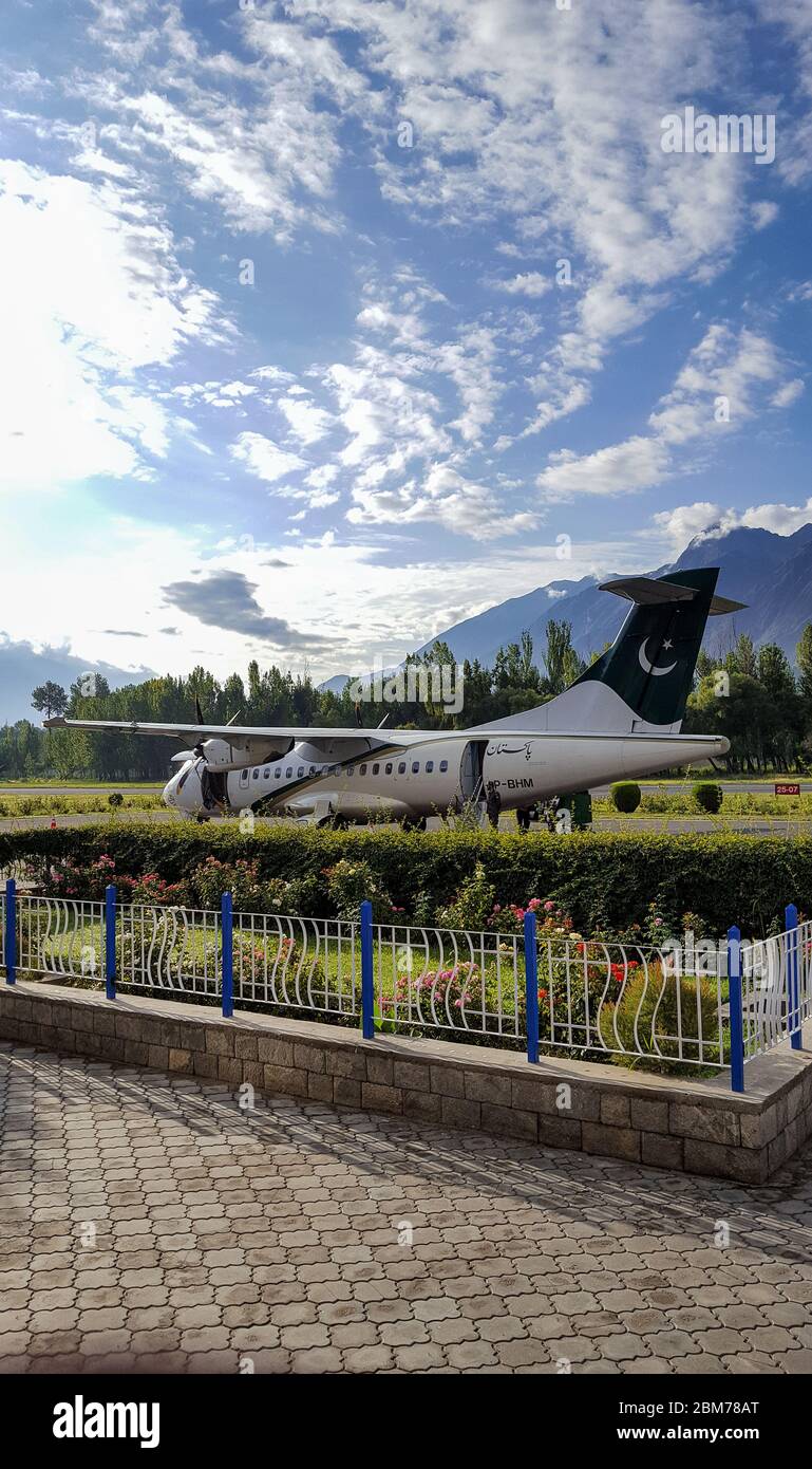 Plane standing at the runway after landing, at beautiful airport of Gilgit Baltistan, Pakistan Stock Photo