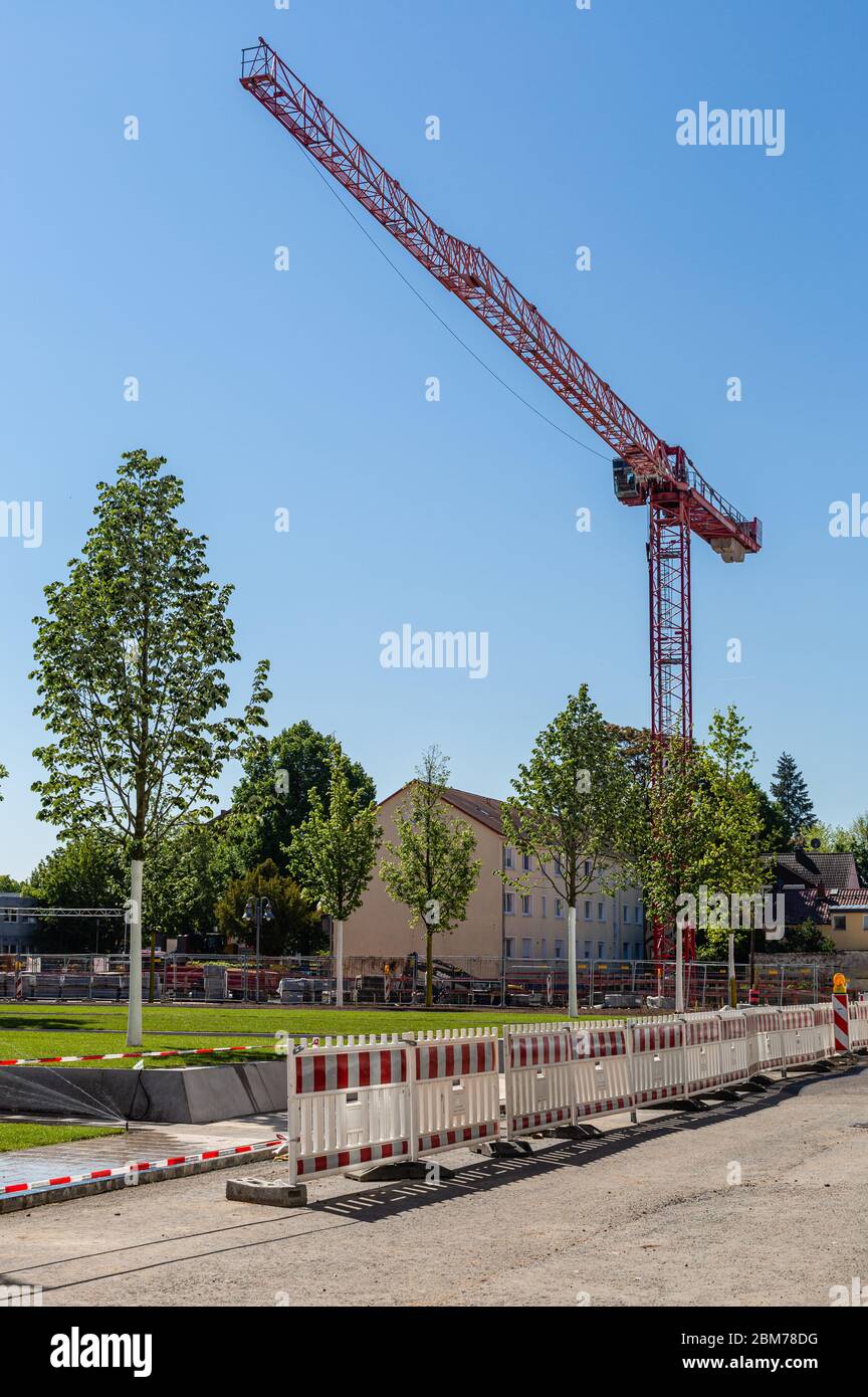 Construction crane . Construction of a new housing estate. City development. Old and modern architecture. Stone walls. Stock Photo