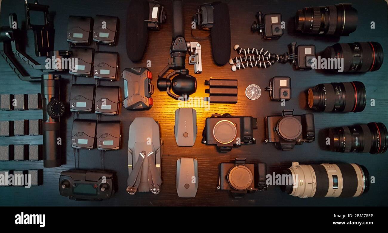 Filmaking Gears On The Table, Cameras, Gimble, Action Cameras and Lenses Stock Photo
