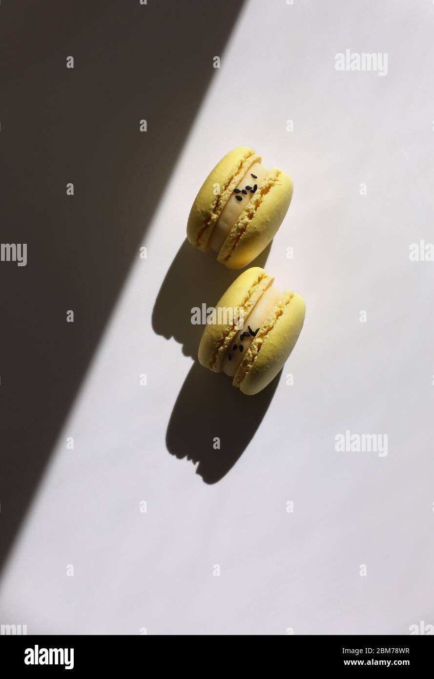Abstract pattern with yellow macaroons or macarons on white background ...